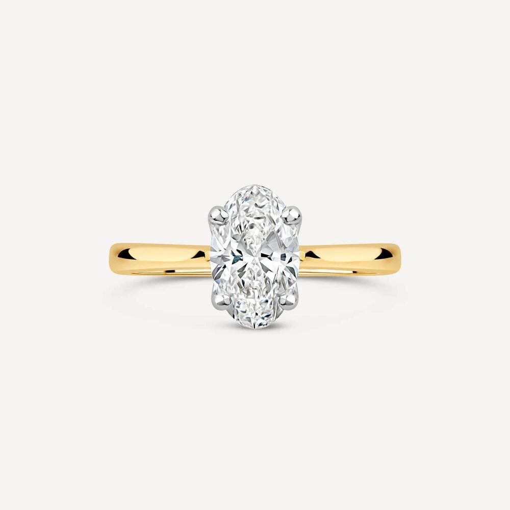 Oval-cut diamond solitaire ring set in a white gold head with a polished yellow gold band.
