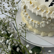 close-up of the cake surrounded by delicate white flowers